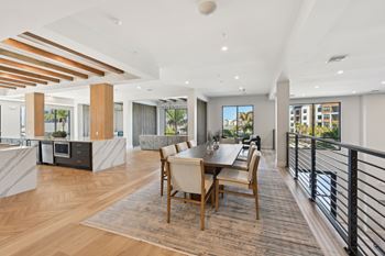 A modern dining room with a wooden table and chairs.